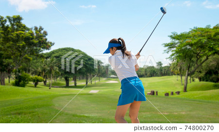 Golfer sport course golf ball fairway. People lifestyle woman playing game golf tee of on the green grass.  74800270