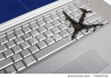 Shadow of jumbo jet over apple macintosh keyboard Shadow of jumbo jet over apple macintosh keyboard 74800592