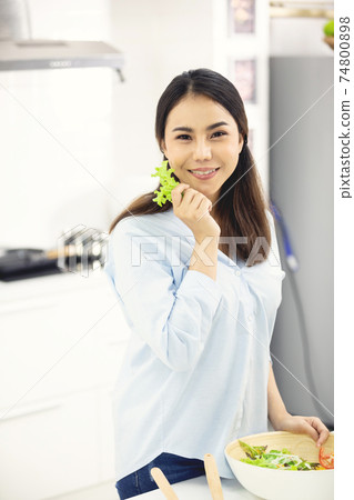 Asian mother making food in the kitchen. Asian mother making food in the kitchen. 74800898