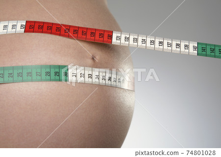 Pregnant Woman Measuring Stomach With Tape Measure Pregnant Woman Measuring Stomach With Tape Measure 74801028