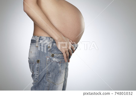 Pregnant Woman Wearing Jeans Pregnant Woman Wearing Jeans 74801032