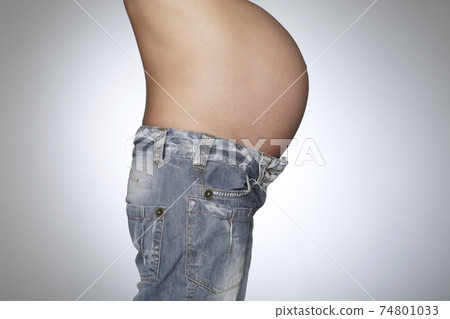 Pregnant Woman Wearing Jeans Pregnant Woman Wearing Jeans 74801033