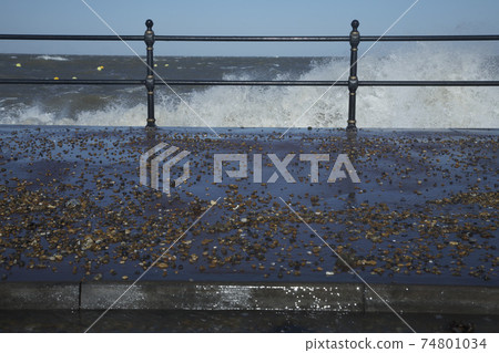 Water crashing over rail Water crashing over rail 74801034