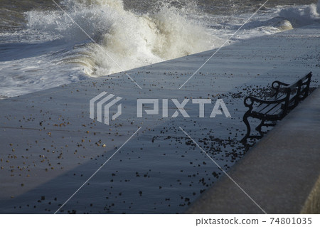 Water crashing on cement pier Water crashing on cement pier 74801035