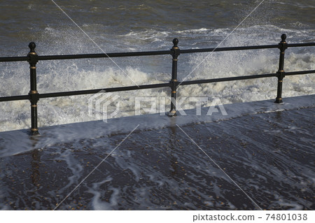 Water crashing over rail 74801038