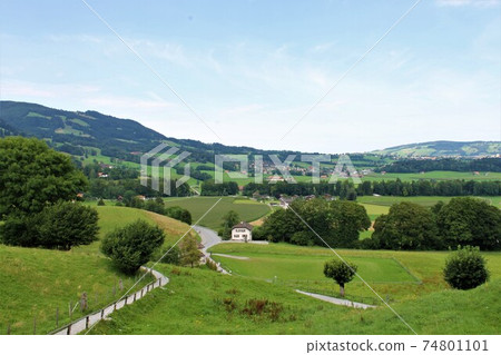 The rural landscape outside Gruyères, Switzerland: A tranquil beauty created by green hills and white houses The rural landscape outside Gruyères, Switzerland: A tranquil beauty created by green hills and white houses 74801101