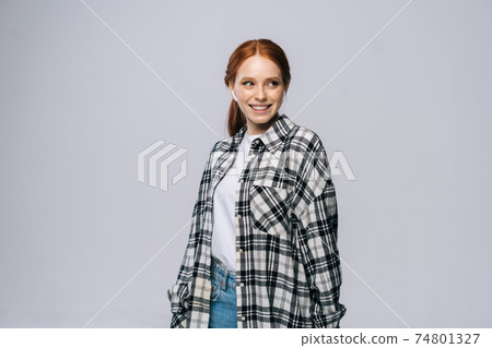 Charming young woman wearing wireless earphones listening popular song on isolated white background Charming young woman wearing wireless earphones listening popular song on isolated white background 74801327