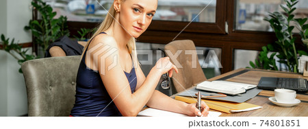 Business woman is writing documents Business woman is writing documents 74801851