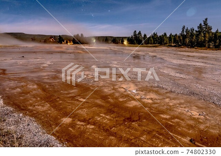 night photo os old faithful geisers in yellowstone national park 74802330