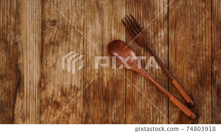 Wooden spoon and fork on wooden background. Asian style wooden appliances 74803918