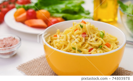 Instant noodles with served with vegetables and herbs 74803978