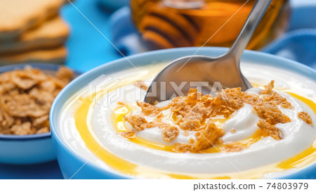 Yogurt with granola and honey, bowl of fresh and healthy breakfast 74803979