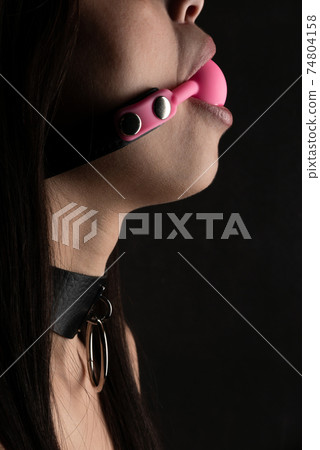 Beautiful woman in the role of a slave on black background 74804158