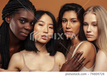 young pretty asian, caucasian, afro woman posing cheerful together on brown background, lifestyle diverse nationality people concept young pretty asian, caucasian, afro woman posing cheerful together on brown background, lifestyle diverse nationality people concept 74804726