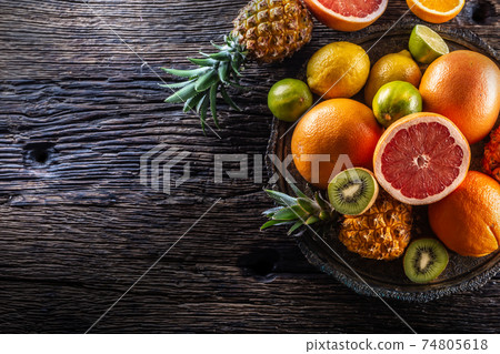 Top view of exotic fruit and citruses on a vintage wood Top view of exotic fruit and citruses on a vintage wood 74805618
