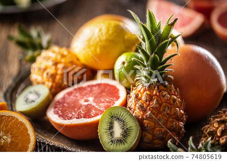 Assortment of fresh exotic fruit ideal for detox on a rustic wood surface Assortment of fresh exotic fruit ideal for detox on a rustic wood surface 74805619