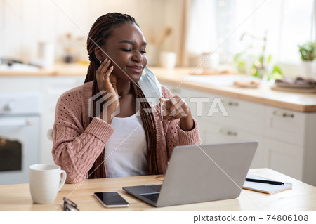 Portrait Of Young Black Woman Scratching Face After Wearing Medical Mask Portrait Of Young Black Woman Scratching Face After Wearing Medical Mask 74806108