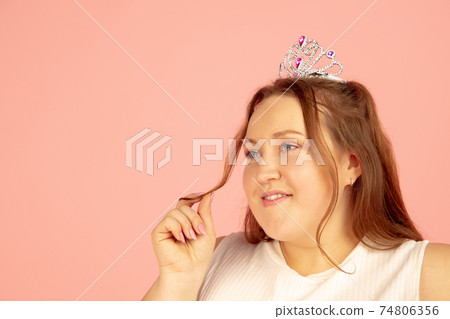 Beautiful caucasian plus size model isolated on pink studio background. Concept of inclusion, human emotions, facial expression 74806356