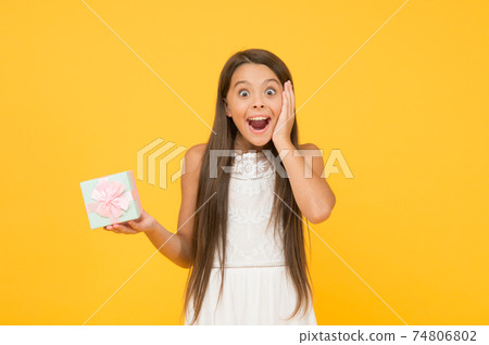 Surprise present. Child hold gift box. Kid delighted gift. Surprise present. Child hold gift box. Kid delighted gift. 74806802