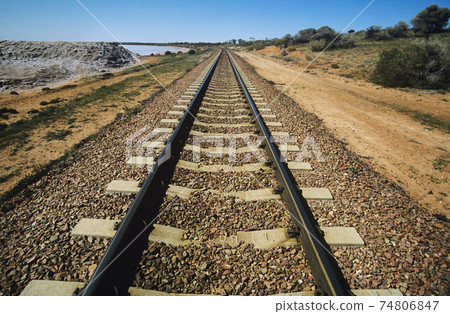 Railroad track in non-urban landscape Railroad track in non-urban landscape 74806847