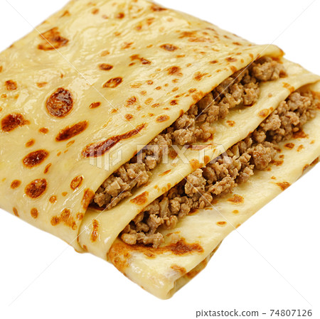 Pancake stuffed by meat white background view Pancake stuffed by meat white background view 74807126