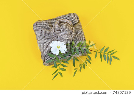 Furoshiki gifts with flowers and leaves. Furoshiki gifts with flowers and leaves. 74807129
