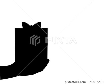 Silhouette of hand holding gift Silhouette of hand holding gift 74807219