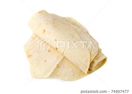 Thin pita bread on a white background. Armenian pita bread close-up. Thin pita bread on a white background. Armenian pita bread close-up. 74807477