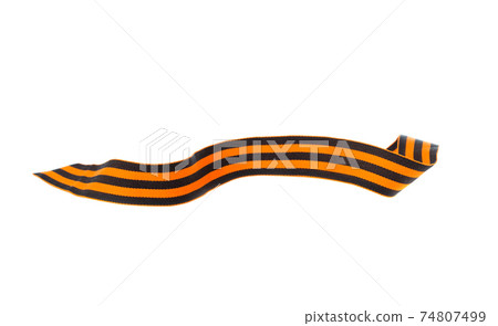 St. George ribbon on a white background. Black orange ribbon close up on a white background. 74807499