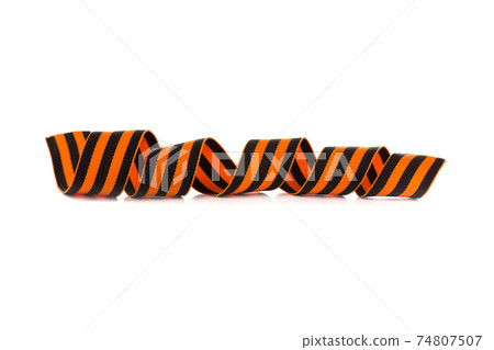 St. George ribbon on a white background. Black orange ribbon close up on a white background. 74807507