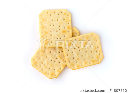 Crackers on a white background. Salty crackers close up on a white background. Crackers on a white background. Salty crackers close up on a white background. 74807850