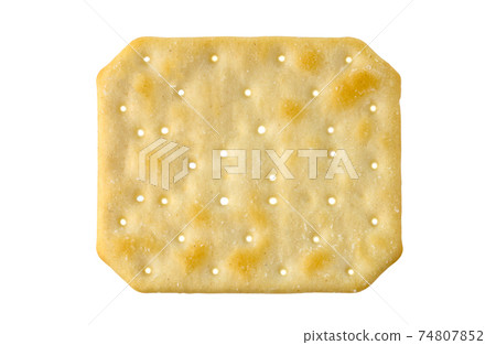 Cracker on a white background. Salty cracker close-up on a white background. 74807852