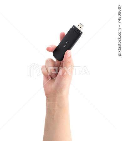 Portable usb modem on a white background. 4g modem in hand on a white background. 74808087
