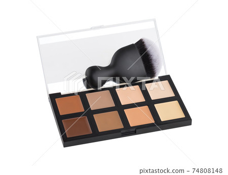 Contouring palette on a white background. Makeup palette of several colors and brush close-up. Contouring palette on a white background. Makeup palette of several colors and brush close-up. 74808148