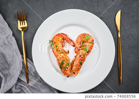 Two shrimps in shape of heart on the plate, top view. Love concept Two shrimps in shape of heart on the plate, top view. Love concept 74808556