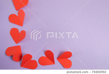 Valentine's Day background. Pink and red hearts on a pastel purple background. Valentine's Day concept. Layout for postcards and congratulations. Flat lay, top view, copy space Valentine's Day background. Pink and red hearts on a pastel purple background. Valentine's Day concept. Layout for postcards and congratulations. Flat lay, top view, copy space 74808992