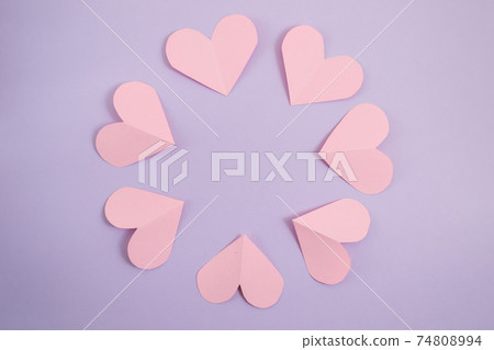 Valentine's day background. Pink hearts laid out in a circle on a pastel purple background. Valentine's day concept. Layout for postcards and congratulations. Flat lay, top view, copy space Valentine's day background. Pink hearts laid out in a circle on a pastel purple background. Valentine's day concept. Layout for postcards and congratulations. Flat lay, top view, copy space 74808994
