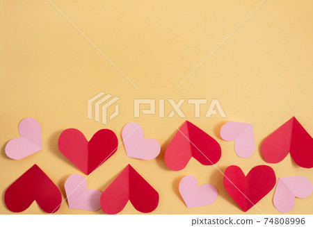 Valentine's Day background. Pink and red hearts on a pastel yellow background. Valentine's Day concept. Flat lay, top view, copy space Valentine's Day background. Pink and red hearts on a pastel yellow background. Valentine's Day concept. Flat lay, top view, copy space 74808996