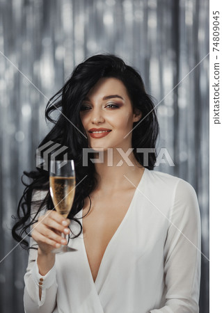 Celebrating Woman in White Dress on Festive Background 74809045