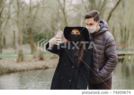 People in a masks stands on the street People in a masks stands on the street 74809674