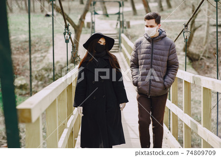 People in a masks stands on the street People in a masks stands on the street 74809709
