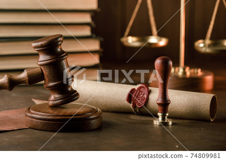 Vintage notary stamp, gavel and sealed document on a wooden table Vintage notary stamp, gavel and sealed document on a wooden table 74809981