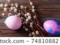 pink, purple easter eggs, willow branches on a dark wooden , top view 74810882