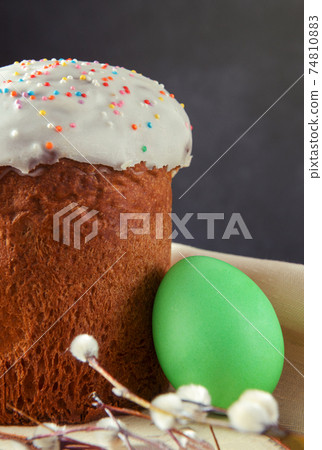 easter cake with willow twigs and 1 green egg on dark 74810883