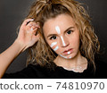 1 blonde woman with white face paint on black background, body art, 74810970