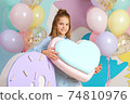 white girl 10 years old with a heart, pastel balloons 74810976