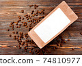 craft pack on a brown wooden background with coffee beans 74810977