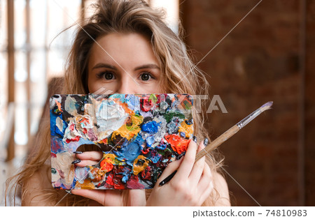 blonde woman with paint in the room 74810983