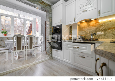 Modern classic white kitchen interior with dining zone Modern classic white kitchen interior with dining zone 74811202