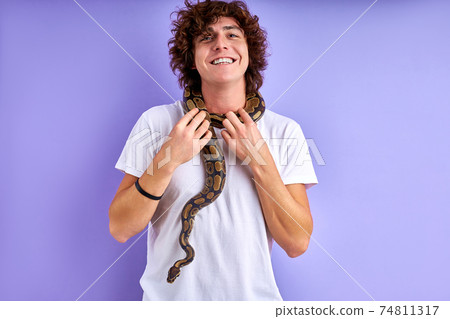 cheerful smiling guy stand brave with snake on him 74811317